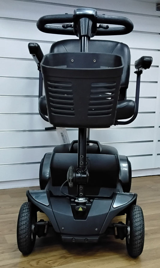 Front view of a fully refurbished Pride Go Go Elite Traveller mobility scooter in grey with black basket and tires