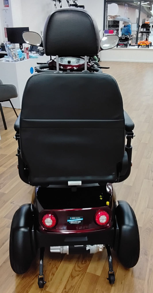 Rear view of a refurbished maroon Roadmaster Plus R mobility scooter with black seat and mirrors indoors