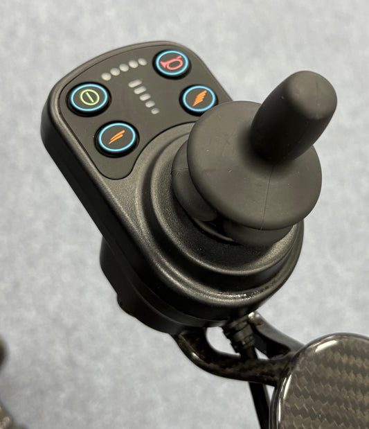 Close-up of joystick control panel on refurbished Quickie Q50 R Carbon black powerchair by Sunrise Medical