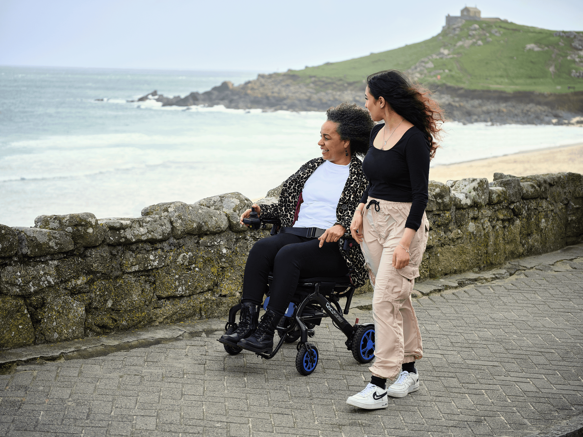 Woman in wheelchair by the seaside