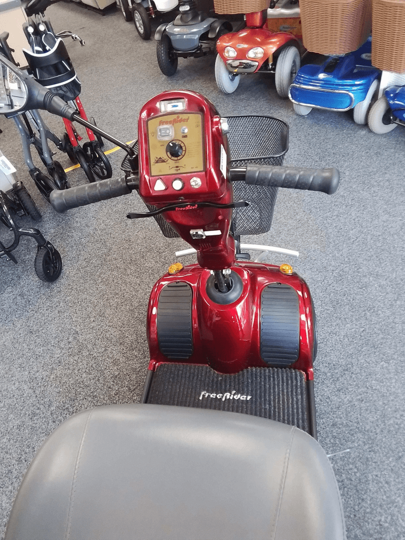 Red Freerider Mayfair mobility scooter in showroom