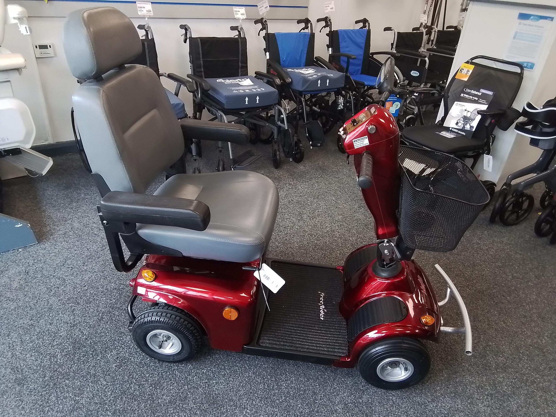 Red Freerider Mayfair mobility scooter in showroom