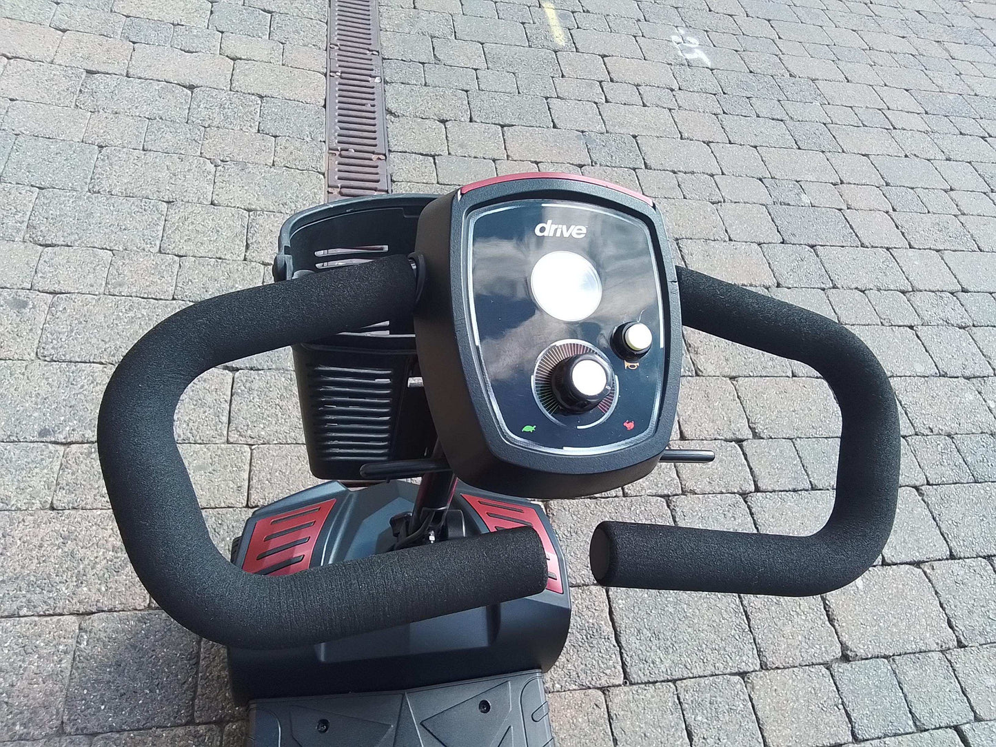 Close up of red Drive Scout mobility scooter