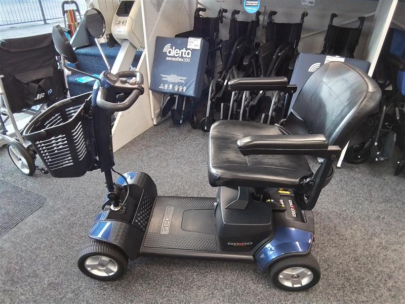 Refurbished Pride Go-Go Elite Traveller blue mobility scooter with basket and comfortable black seat on display indoors