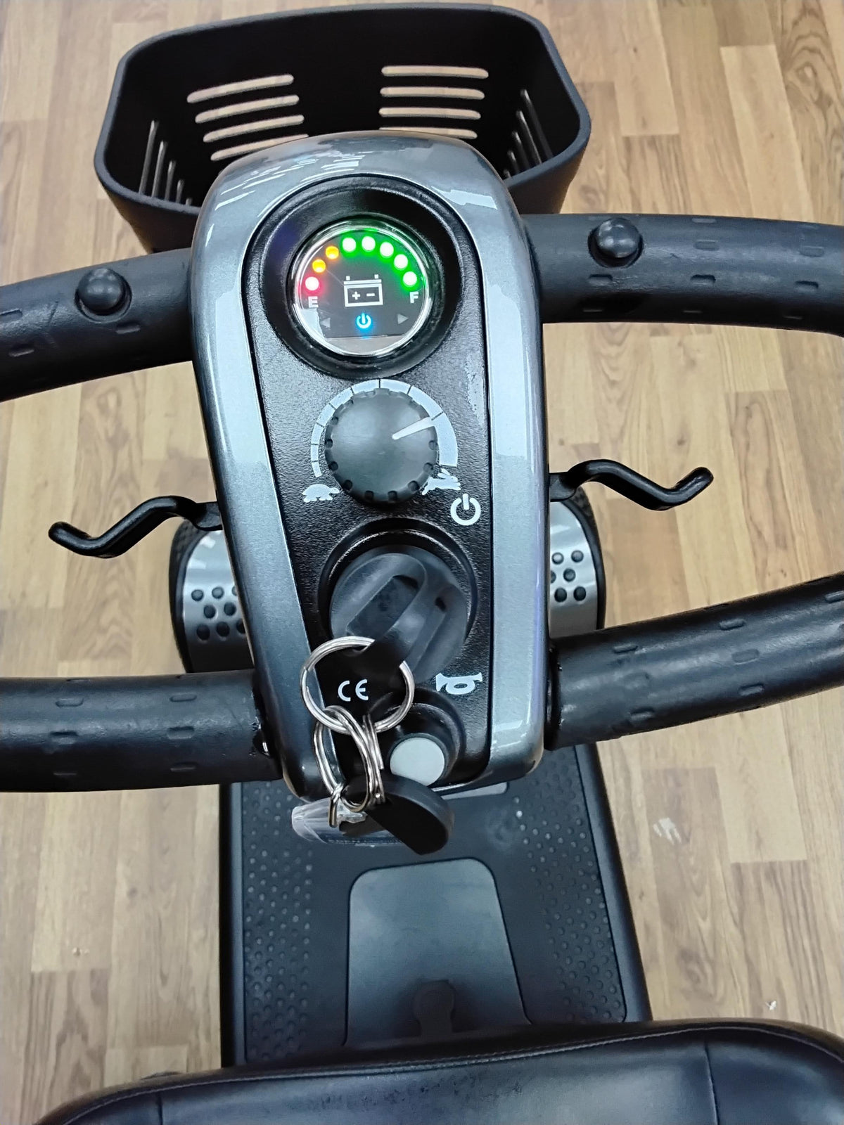 Close-up view of the control panel and handlebars of a refurbished Pride Go Go Elite Traveller scooter in grey.