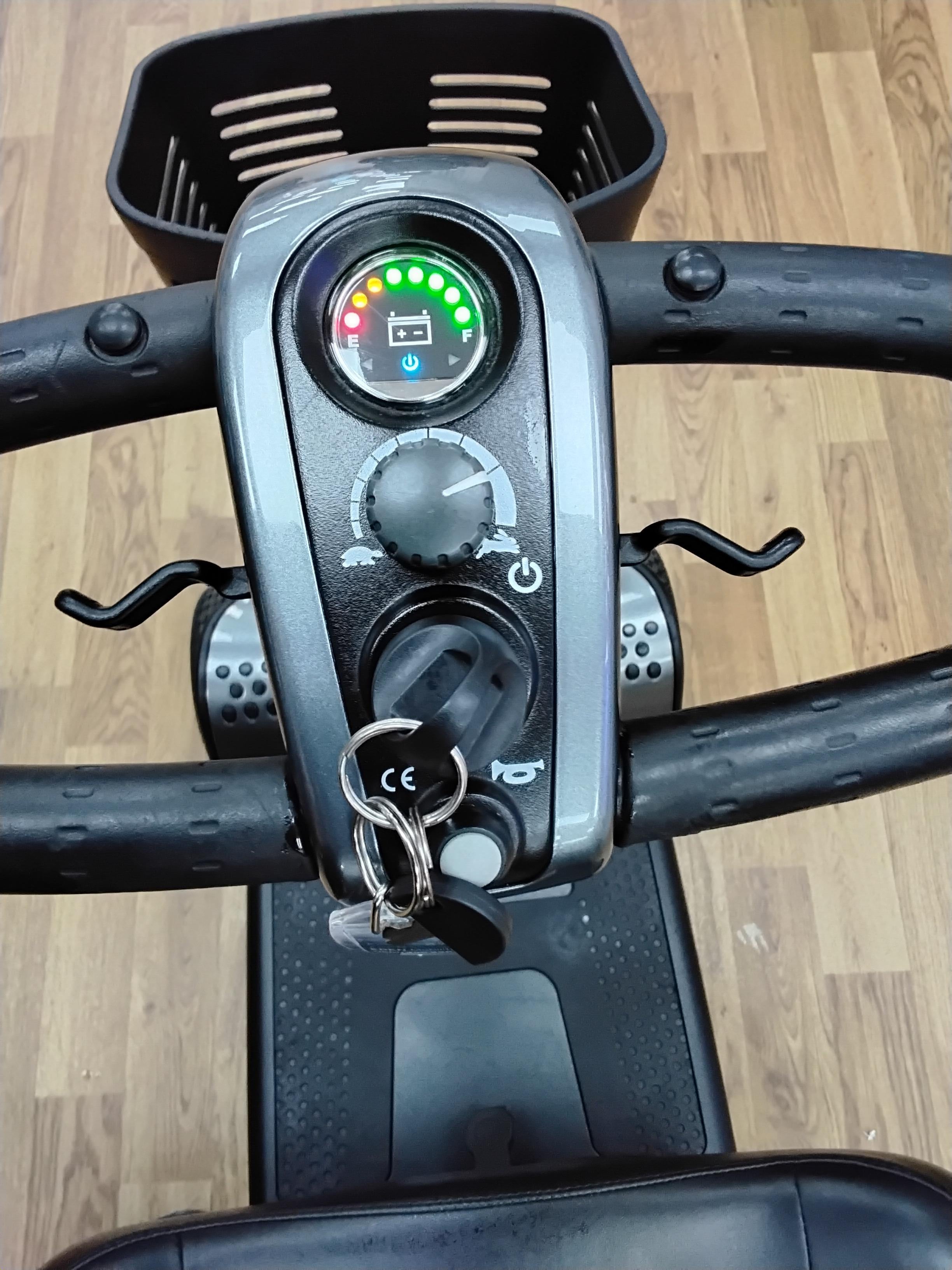Close-up view of the control panel and handlebars of a refurbished Pride Go Go Elite Traveller scooter in grey.