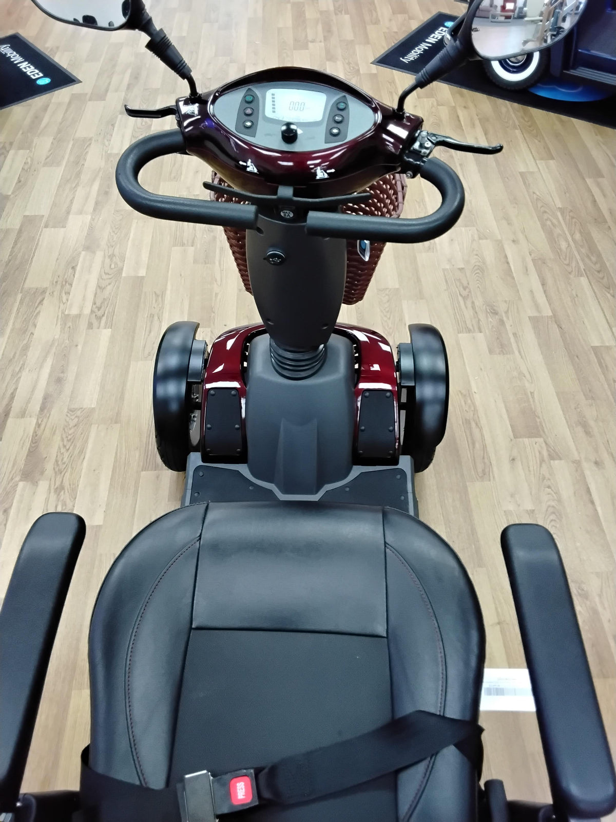 Top-down view of a fully refurbished maroon Roadmaster Plus R mobility scooter on wooden floor