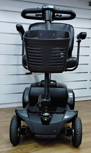 Front view of a fully refurbished Pride Go Go Elite Traveller mobility scooter in grey with black basket and tires