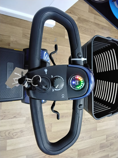 Control panel and handlebar of Pride Go Go Elite Traveller mobility scooter with key and battery indicator lights