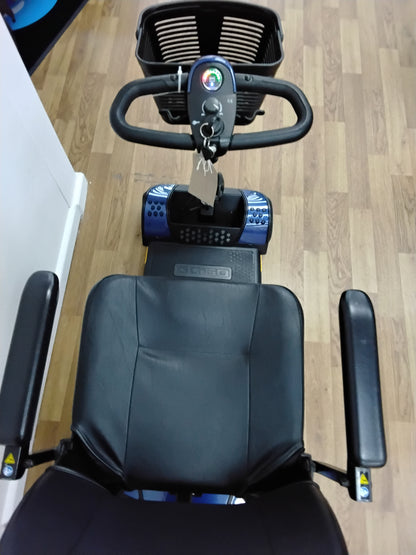 Top view of refurbished Pride Go-Go Elite Traveller mobility scooter in blue with black seat and armrests on wooden floor