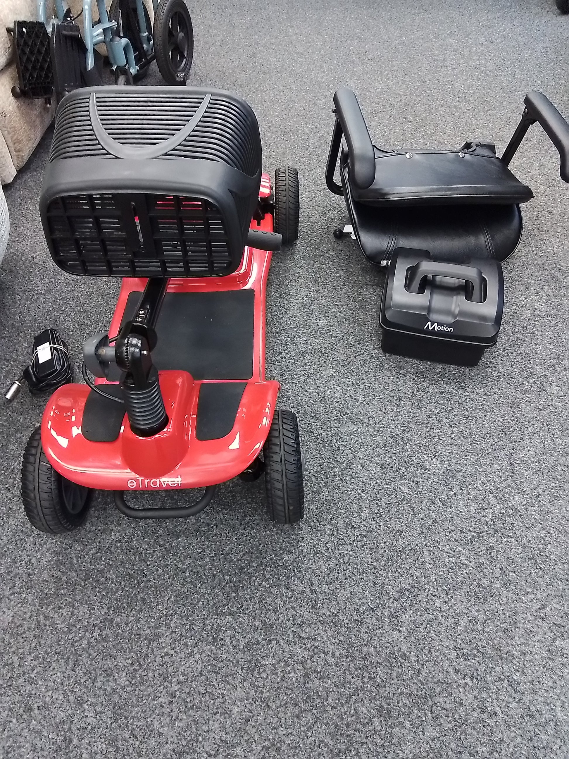 Motion eTravel folded view (red) - Eden Mobility