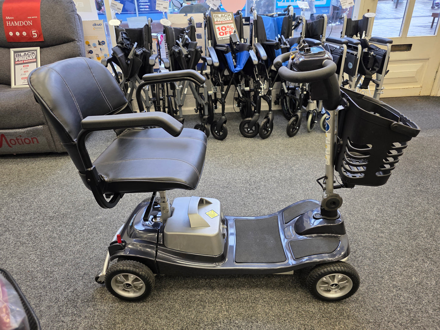 Refurbished Liberty komfi Rider grey mobility scooter with basket, armrests, and comfortable black seat displayed indoors