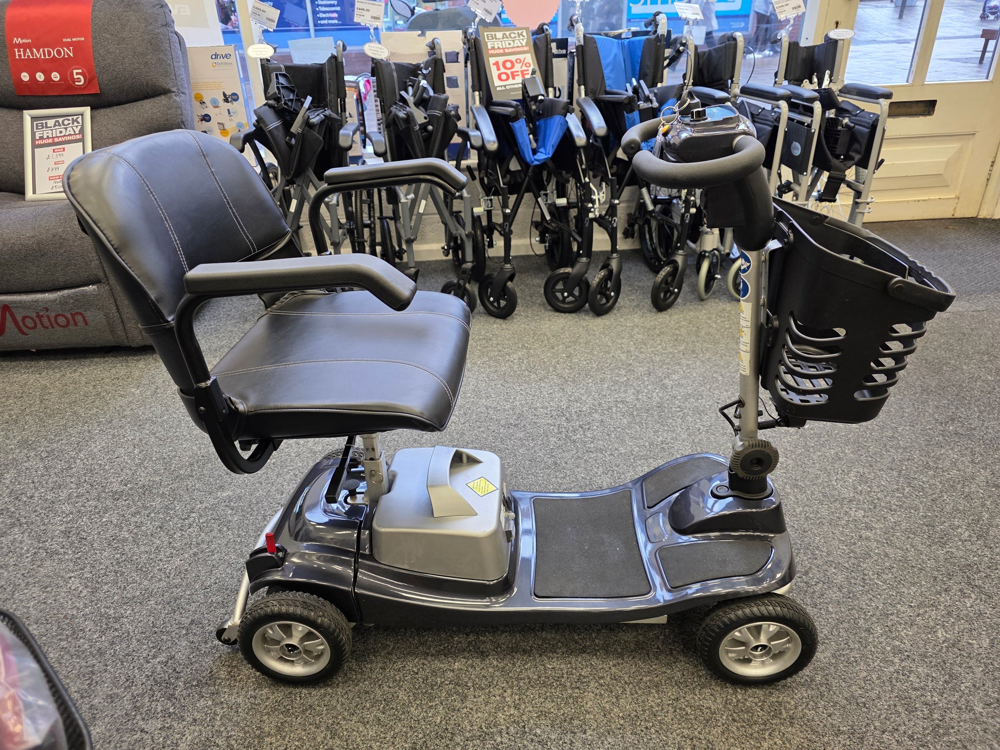 Refurbished Liberty komfi Rider grey mobility scooter with basket, armrests, and comfortable black seat displayed indoors