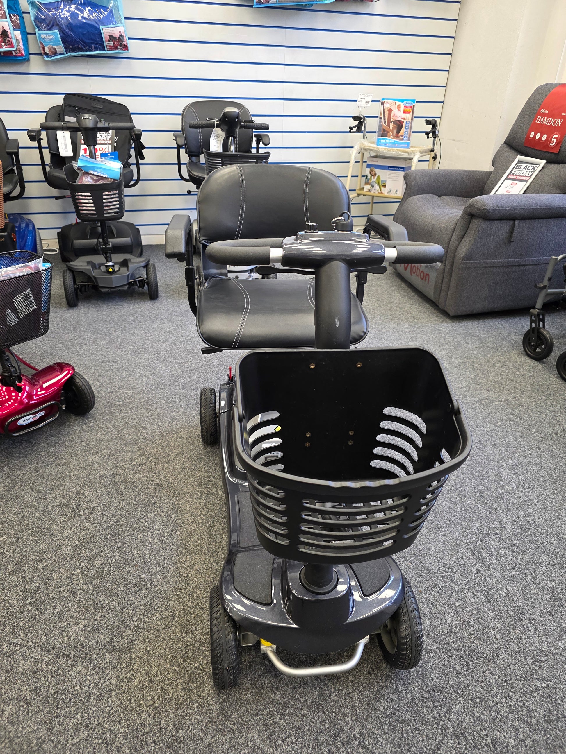 Refurbished Liberty Komfi Rider grey mobility scooter with front basket displayed in showroom interior.