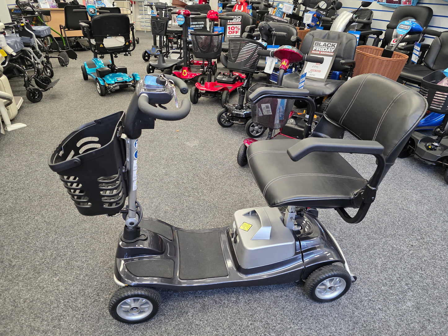 Refurbished Liberty Komfi Rider grey mobility scooter with comfortable seat and front basket in showroom setting