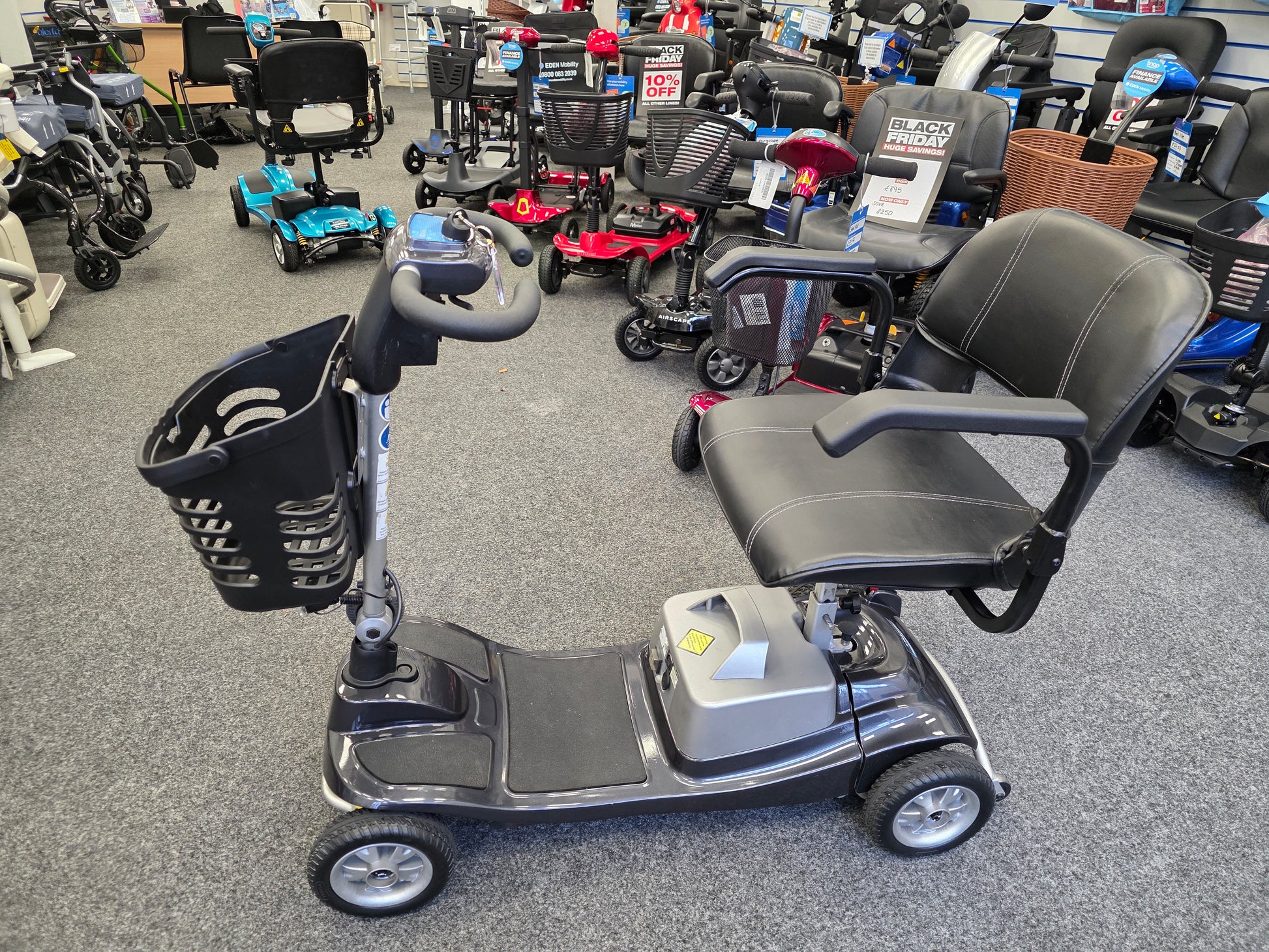 Refurbished Liberty Komfi Rider grey mobility scooter with comfortable seat and front basket in showroom setting