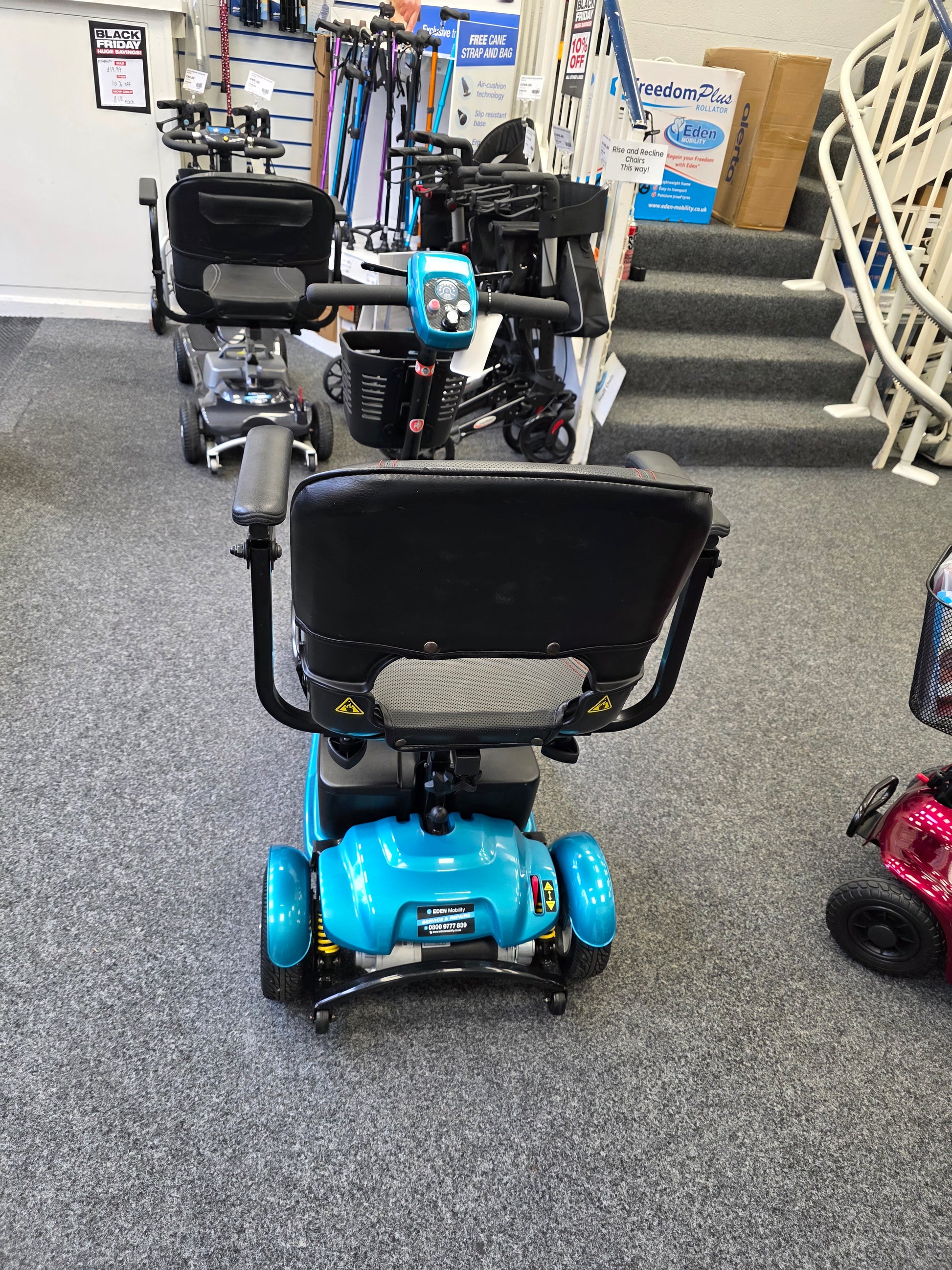 Refurbished blue Li-tech Air mobility scooter with black seat and armrests displayed indoors on grey carpet floor