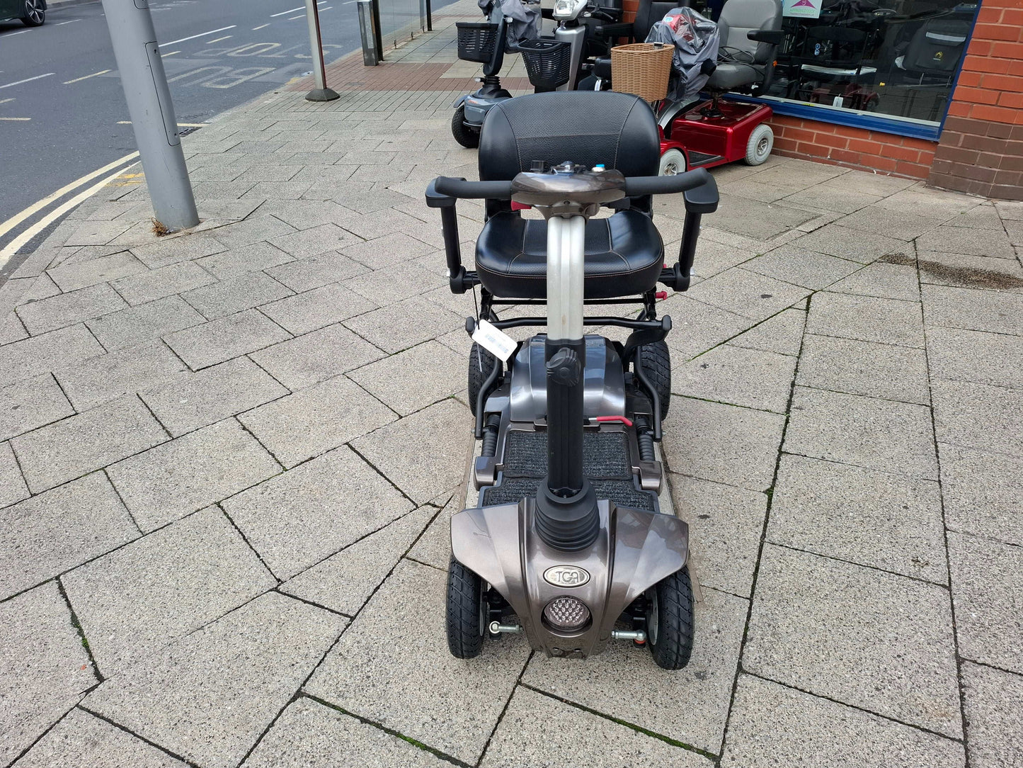 Bronze TGA Maximo scooter on pavement
