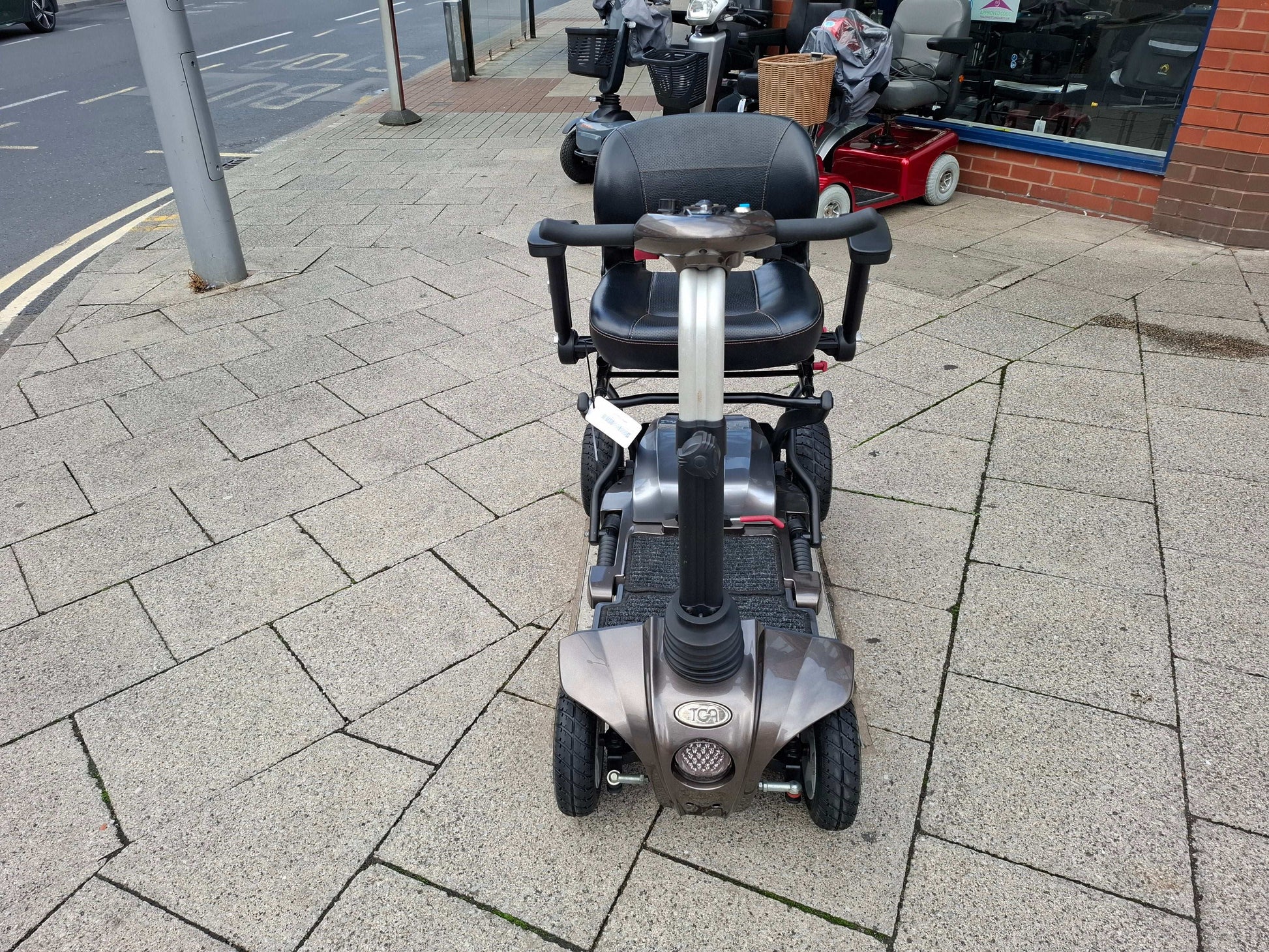 Bronze TGA Maximo scooter on pavement