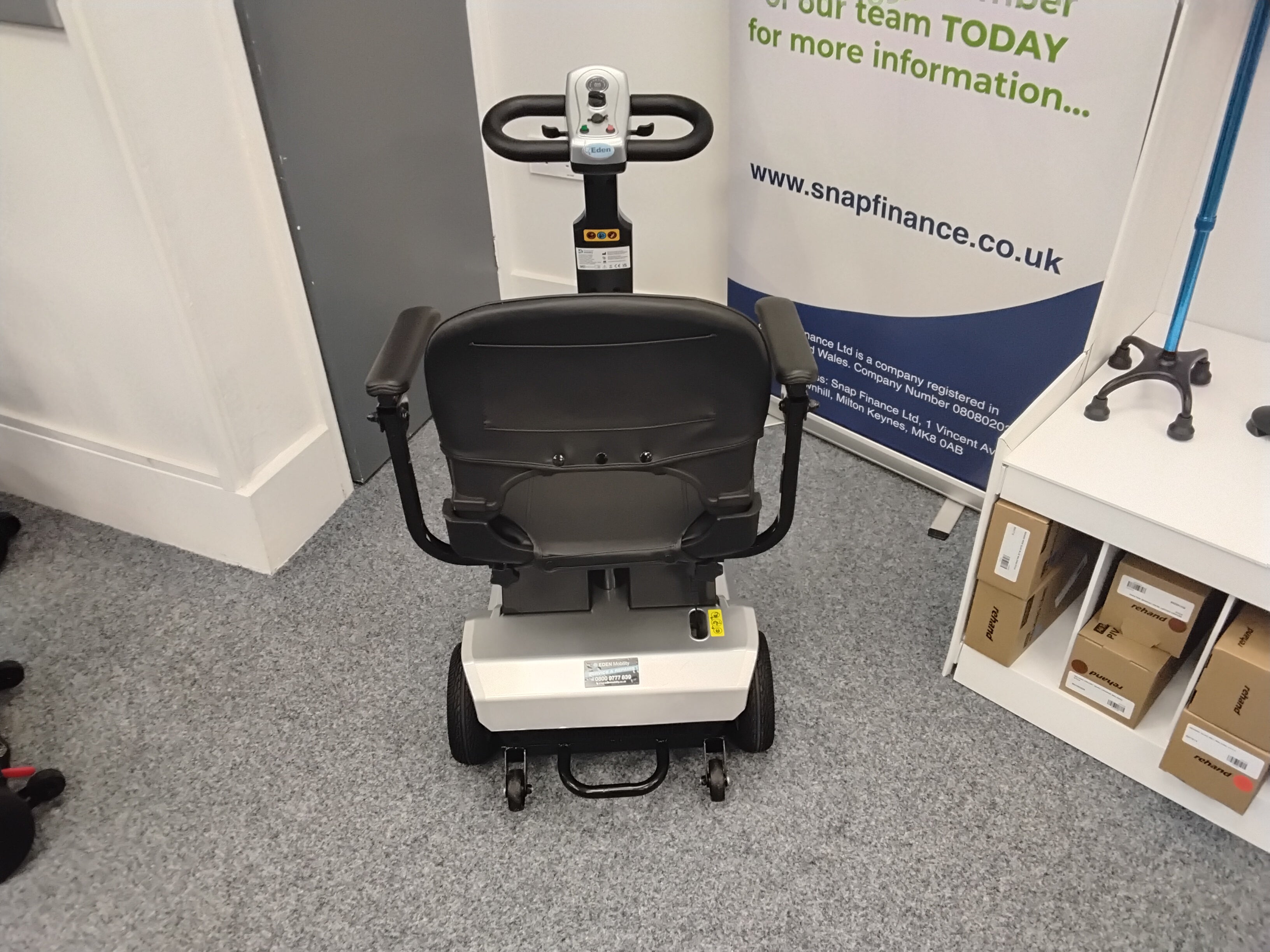Rear view of a refurbished Cruise Rider Silver scooter in an indoor office setting with carpet flooring.