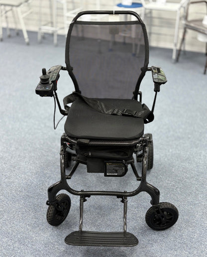 Refurbished Sunrise Medical Quickie Q50 R Carbon powerchair in black with joystick controls and mesh backrest on carpeted floor.