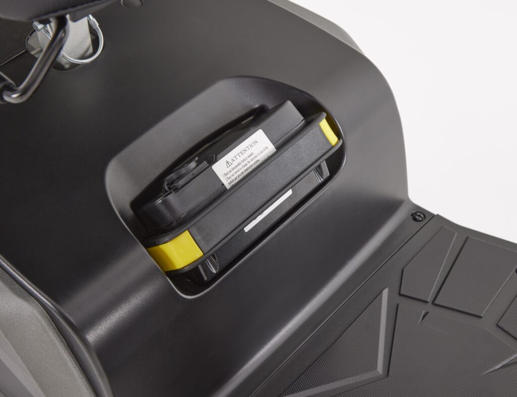 Close-up of the removable battery pack in The Eden Essential Aura 4mph Boot Mobility Scooter platform area