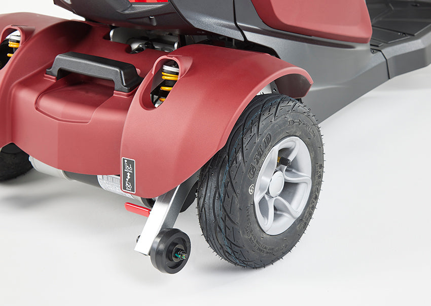 Close-up of the rear wheel and suspension system on the Eden Essential Aura 4mph mobility scooter in red.