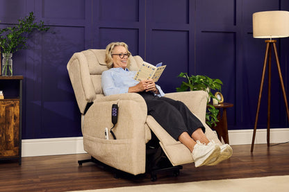 Woman relaxing in cream Sanford Rise and Recliner with footrest extended in a stylish living room setting