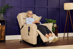 Woman relaxing in cream Sanford Rise and Recliner with footrest extended in a stylish living room setting