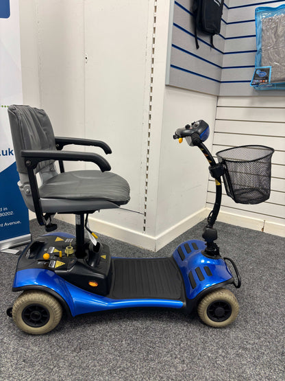 Side view of  Roma Cameo blue mobility scooter in shop