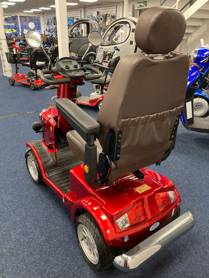 Refurbished red Eden Gatsby mobility scooter with padded brown seat and armrests on blue carpeted showroom floor