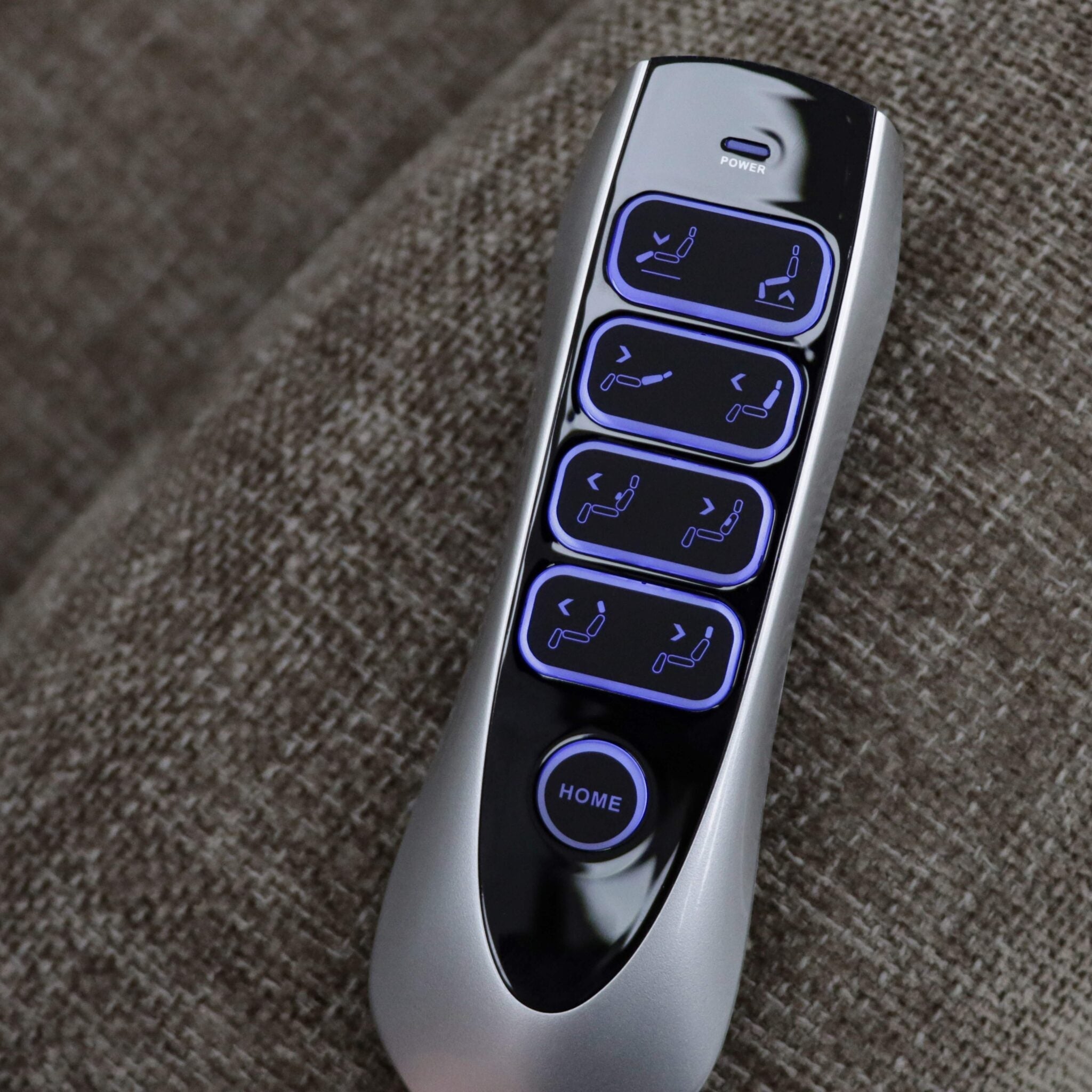 Remote control for Lawson Riser Recliner Chair with buttons for reclining and lifting functions on a textured fabric background