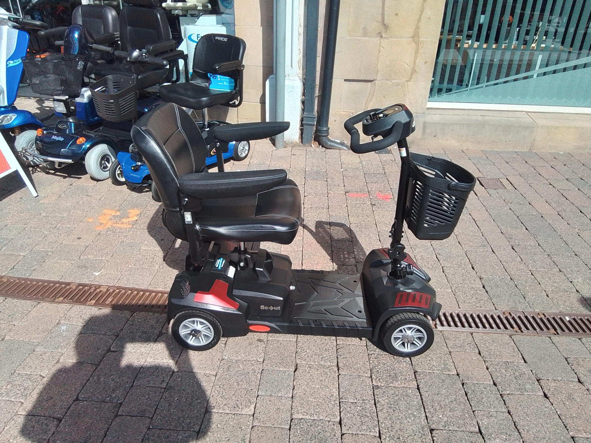 Red Drive Scout mobility Scooter outside
