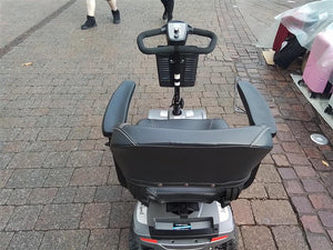 Rear view of a fully refurbished grey Rascal Veo Sport mobility scooter with comfortable seat and armrests on pavement