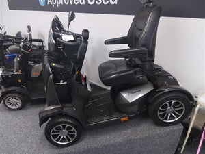 Grey Drive King Cobra mobility scooter fully refurbished with leather seat and alloy wheels, shown in showroom setting.