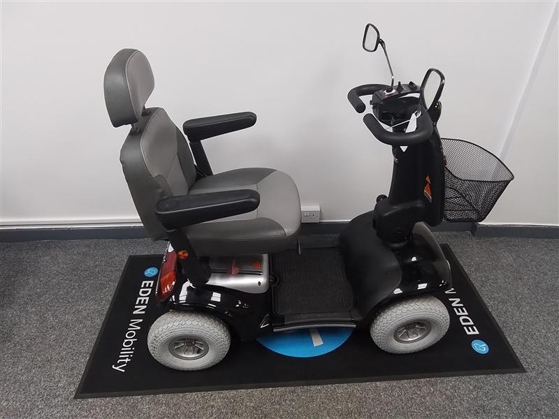 Refurbished Roma Shoprider Cadiz black mobility scooter with padded seat and armrests on showroom floor mat