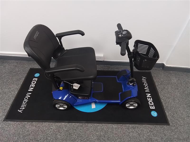 Refurbished Pride Apex Lite Blue mobility scooter with black seat and basket on EDEN Mobility mat