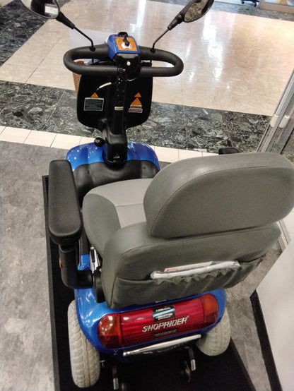 Rear view of refurbished Roma Shoprider Cadiz mobility scooter in blue with cushioned seat and mirrors
