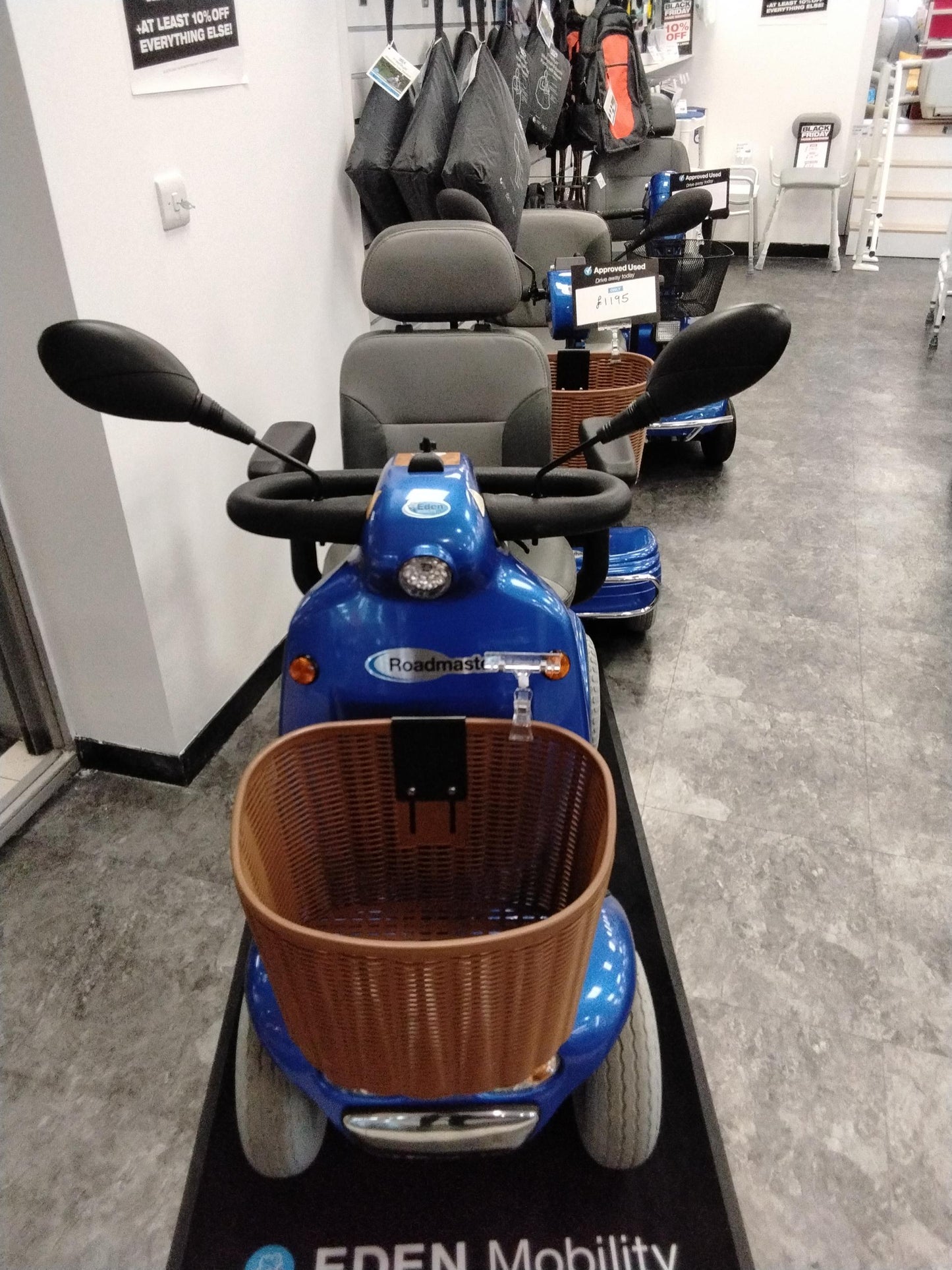 Refurbished blue Roma Shoprider Cadiz mobility scooter with front basket and comfortable seat in showroom setting