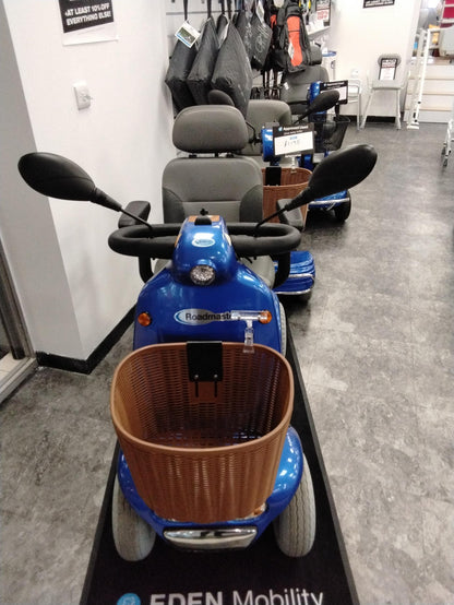 Refurbished blue Roma Shoprider Cadiz mobility scooter with front basket and comfortable seat in showroom setting
